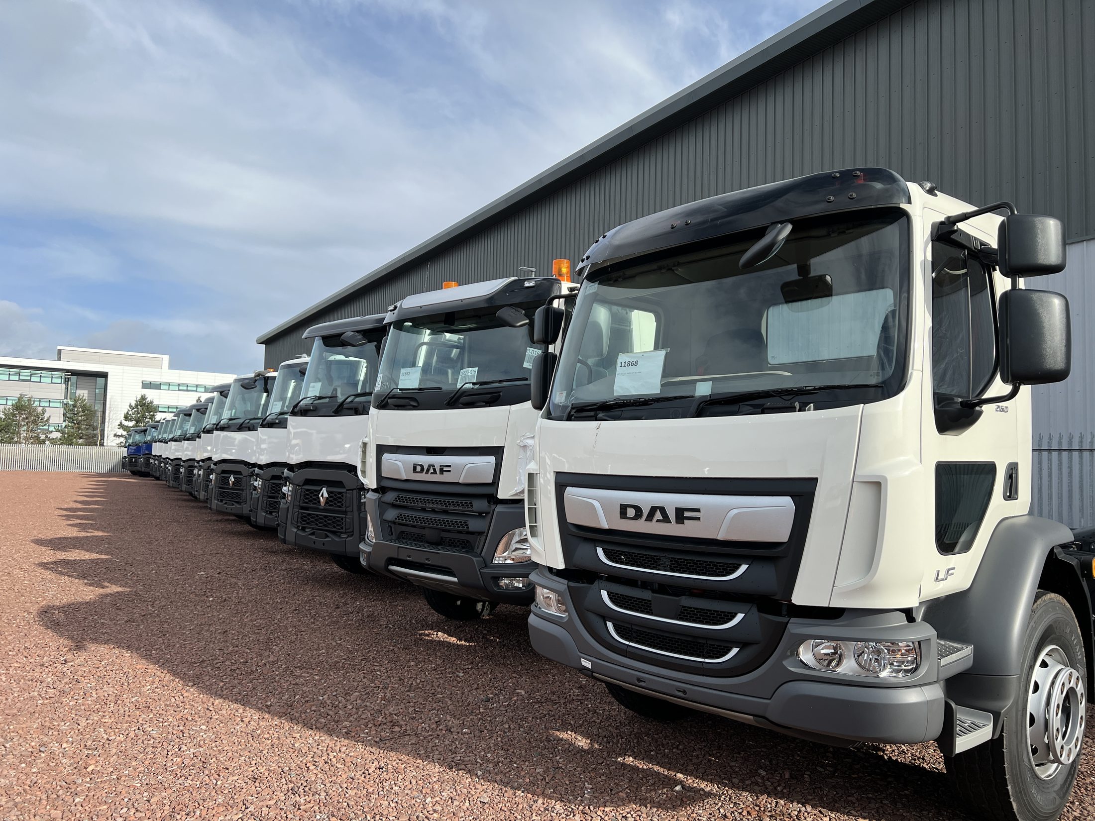A line of lorries parked outside a depot